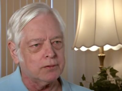 Ted Jorgensen is wearing a light blue polo shirt.